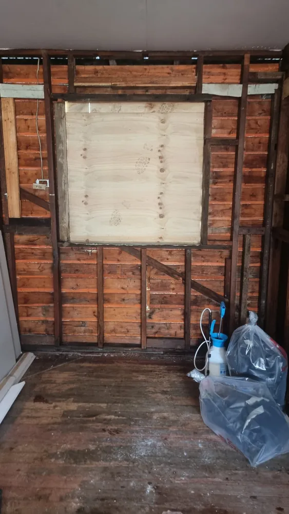 Wall sheeting removed and the area made safe